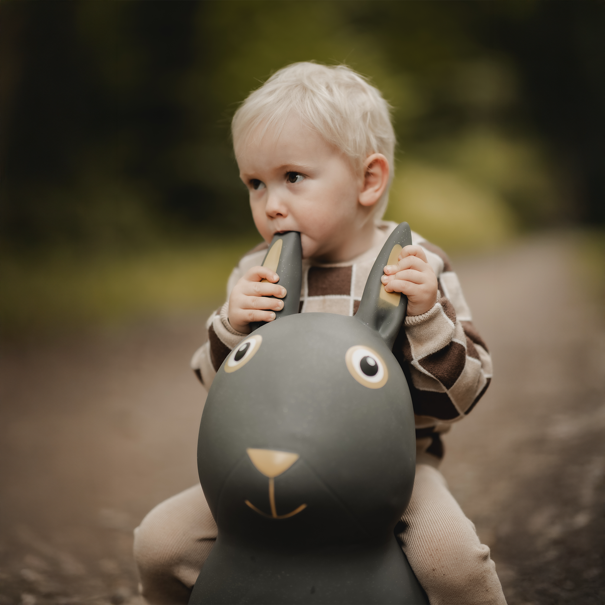 Child playing with Thumper bouncing bunny toy on forest path – Find That Hippo