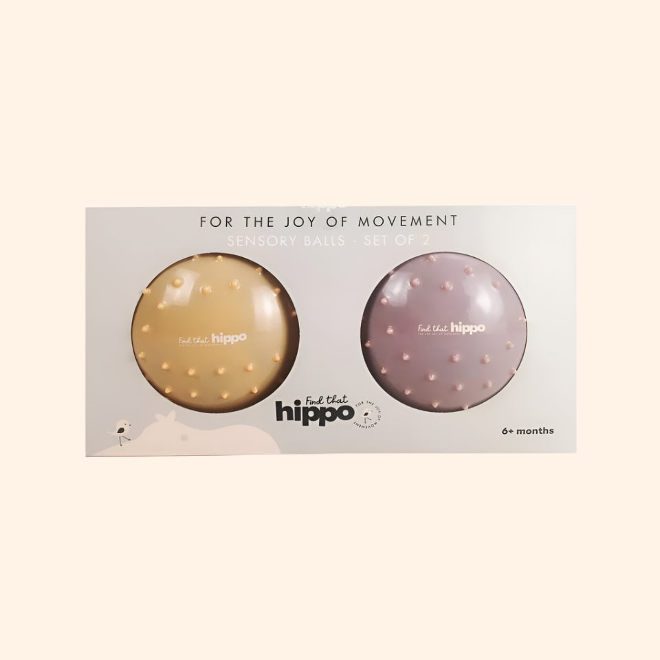Product packaging open to reveal two sensory balls – dusty pink and muted orange – from Find That Hippo