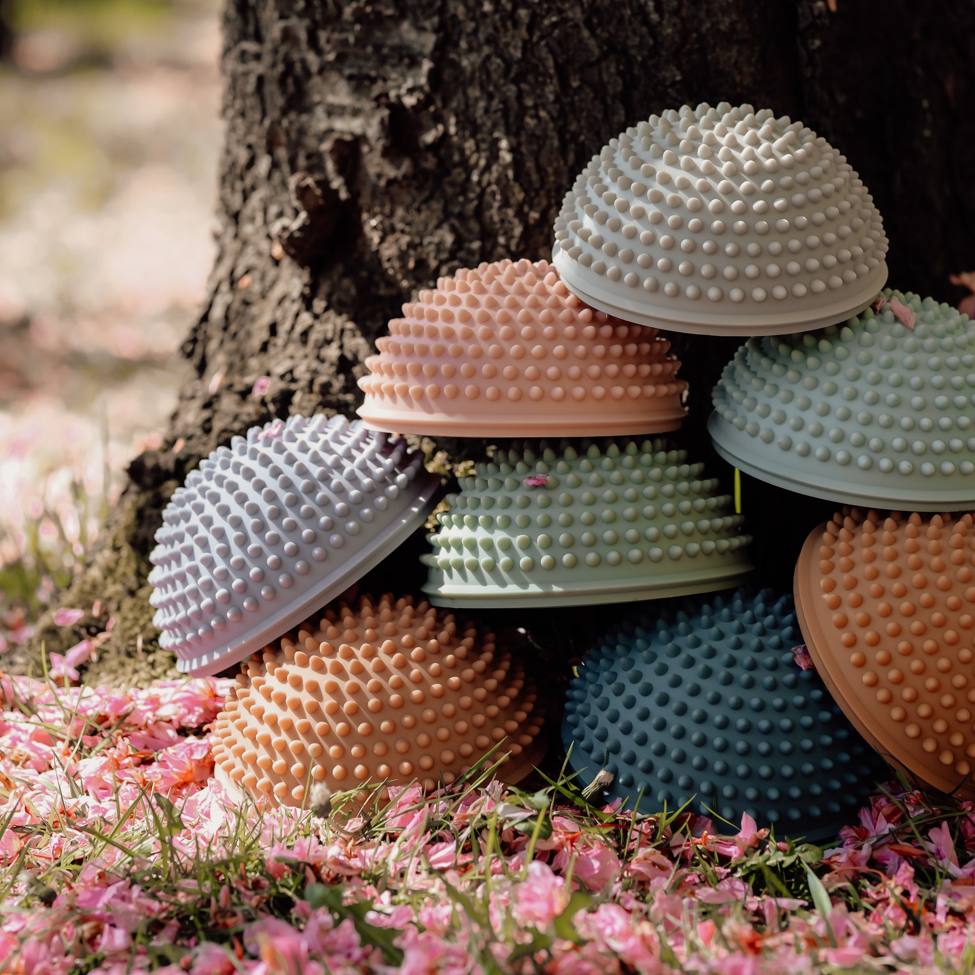 Side view of  Solopgang sensory stones in multiple colors with matte finish and tactile knobs – Find That Hippo